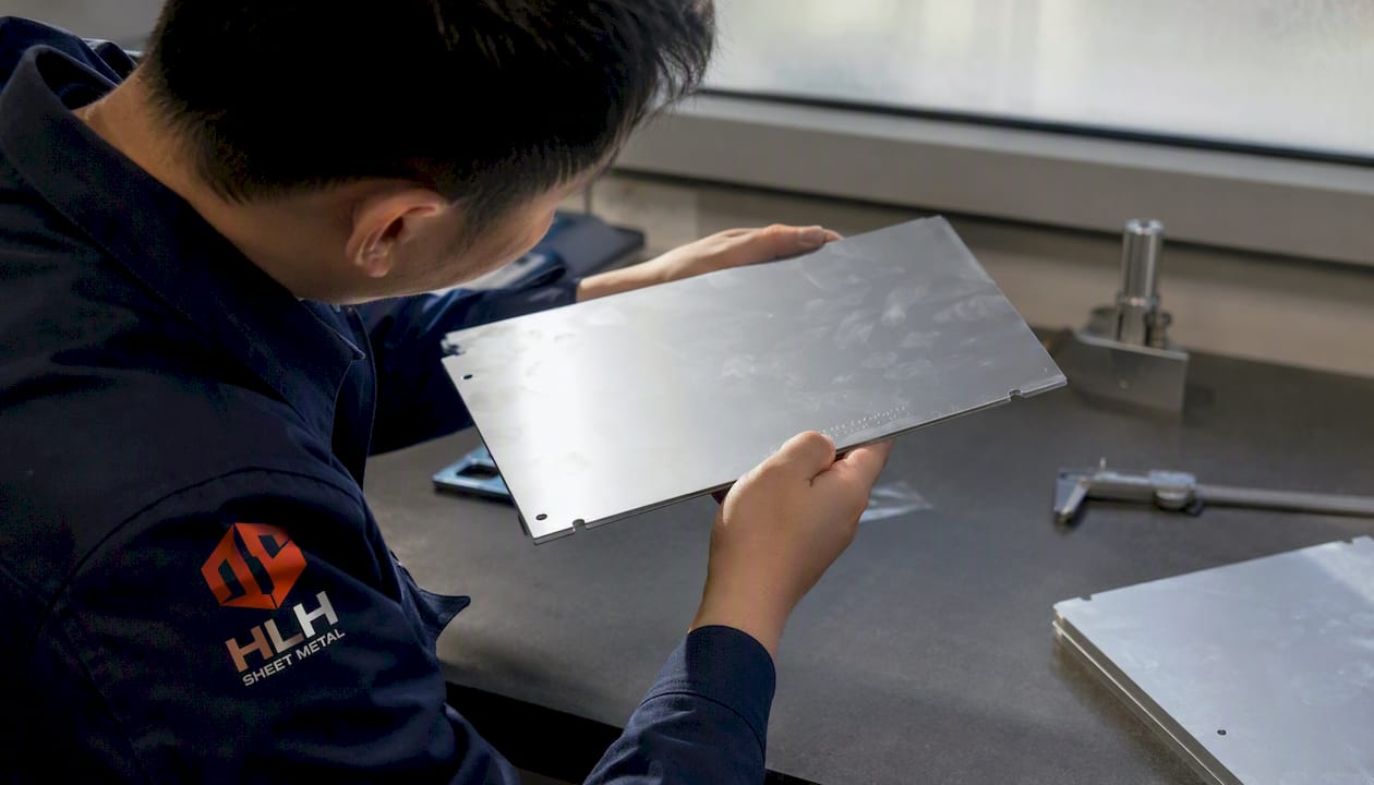 Inspector examining traceability marking on aluminum sheet