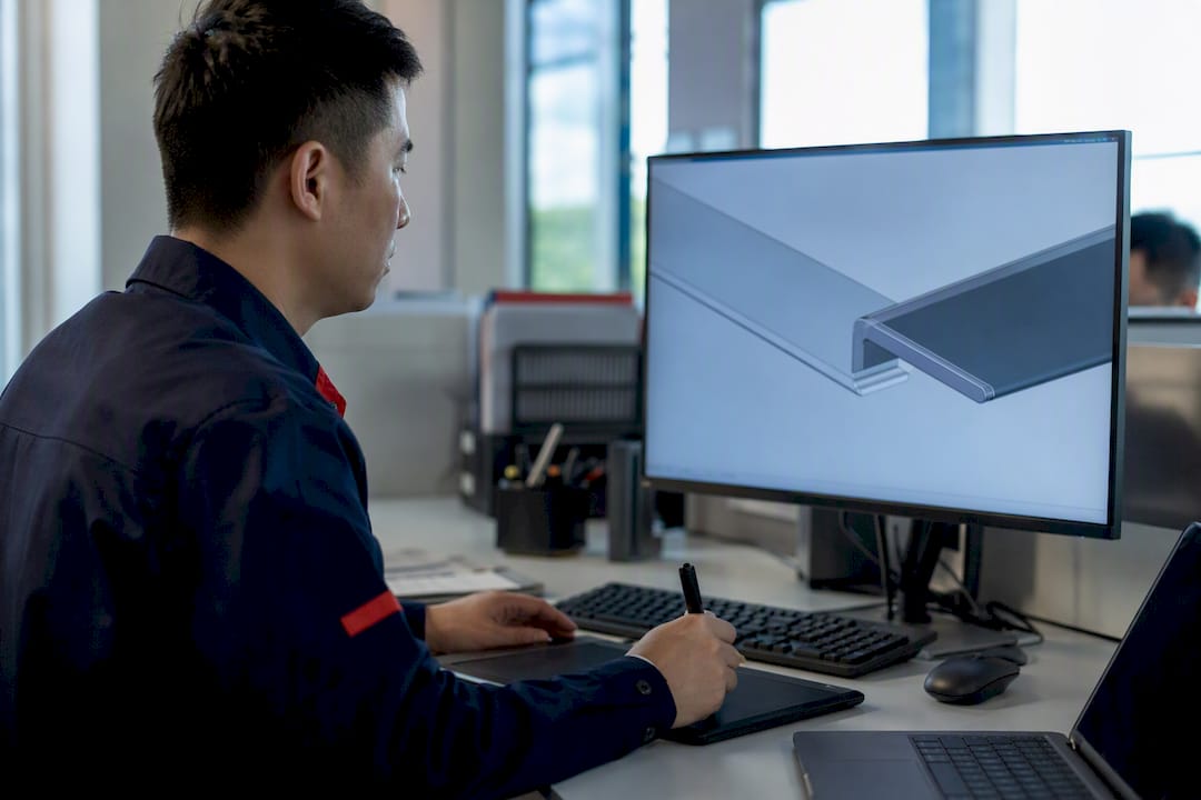 Engineer designing hem flat step on CAD model