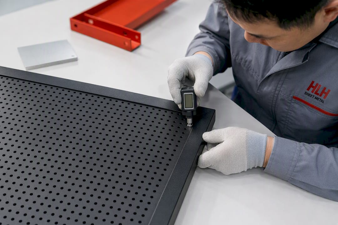 Technician measuring powder-coated perforated steel