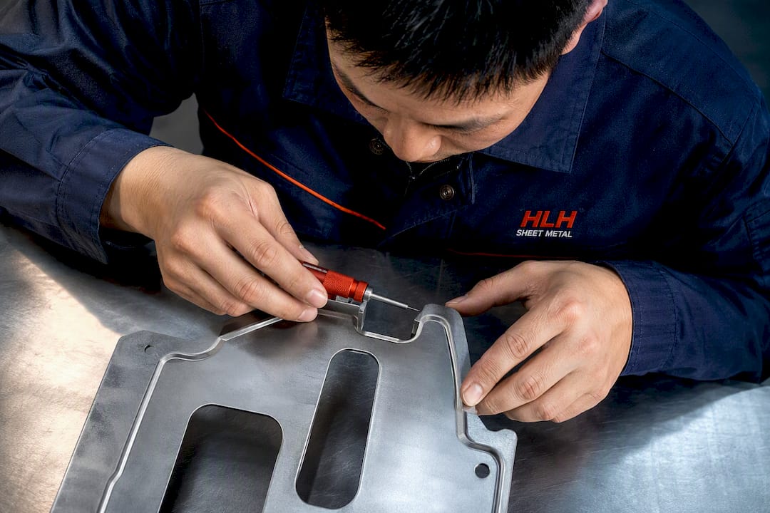 Engineer checking burrs at four positions after Progressive Die Stamping