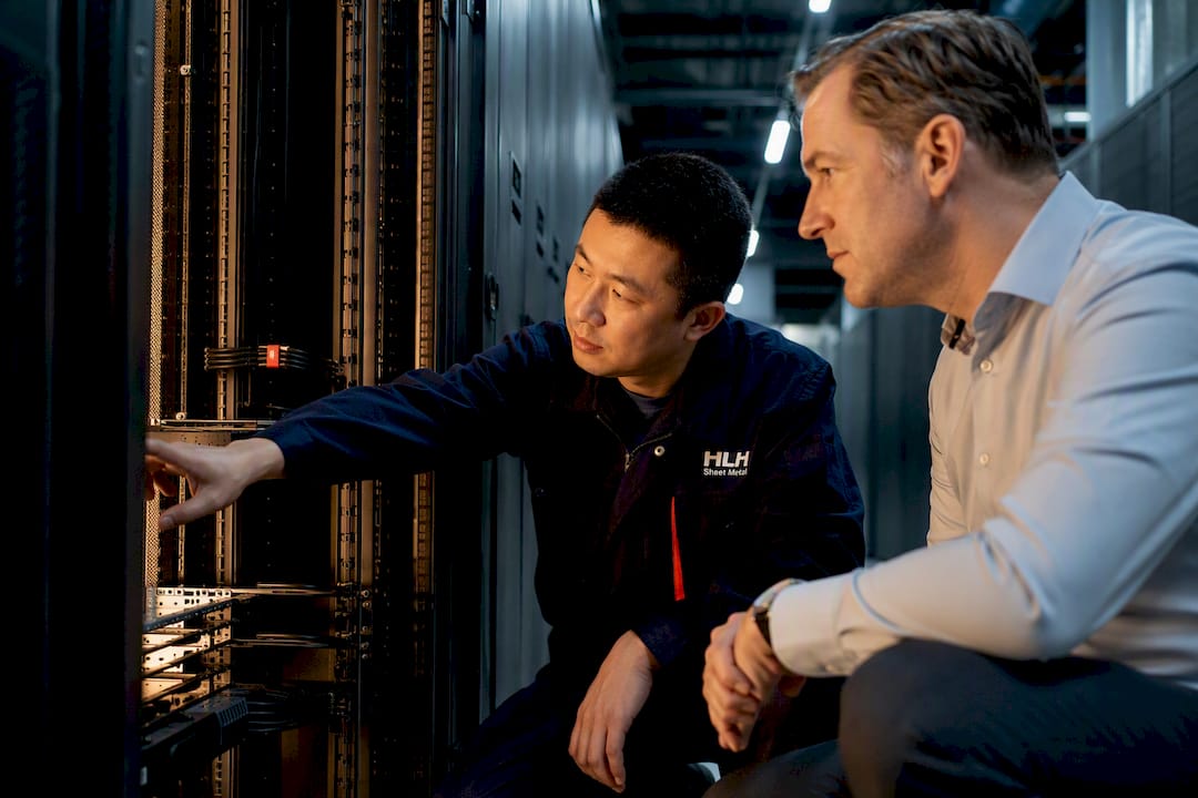 rack cable management - Engineer inspecting organized rack cable managers