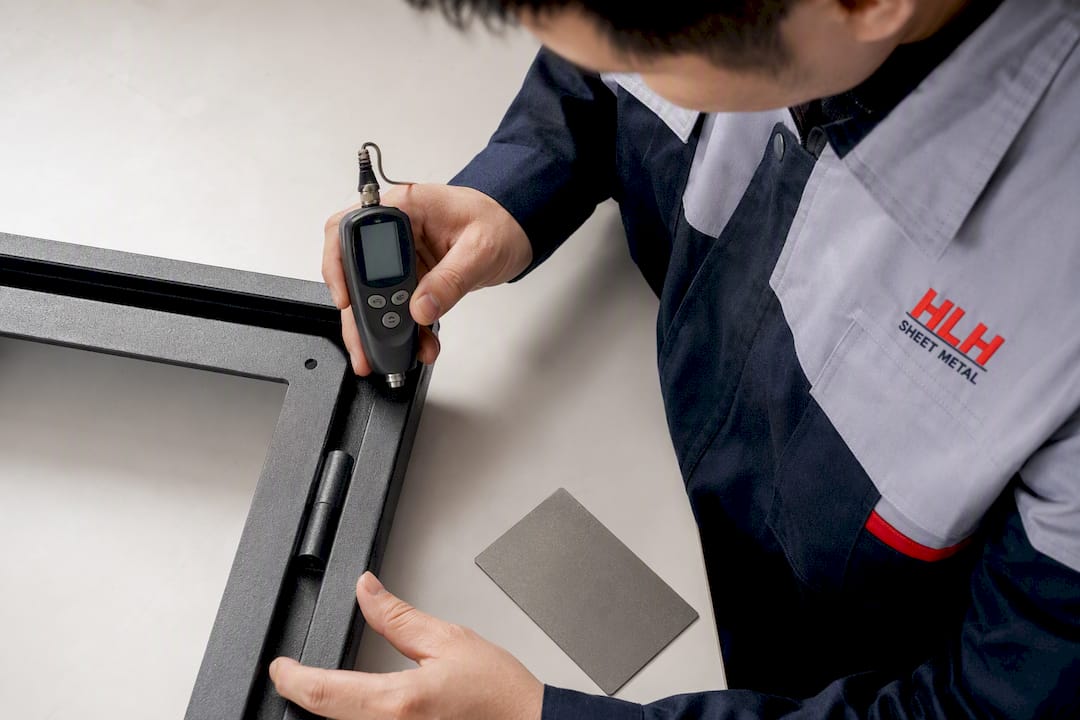 Technician measuring coating on enclosure edge