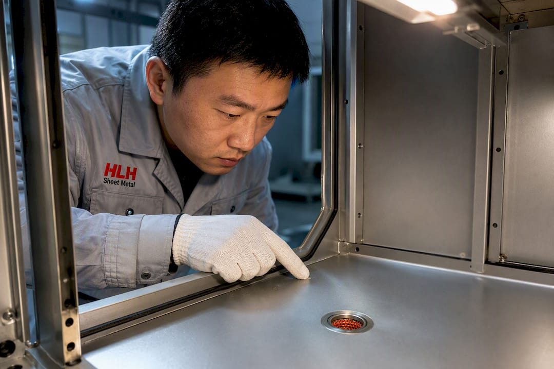 Engineer inspecting enclosure drain and gasket