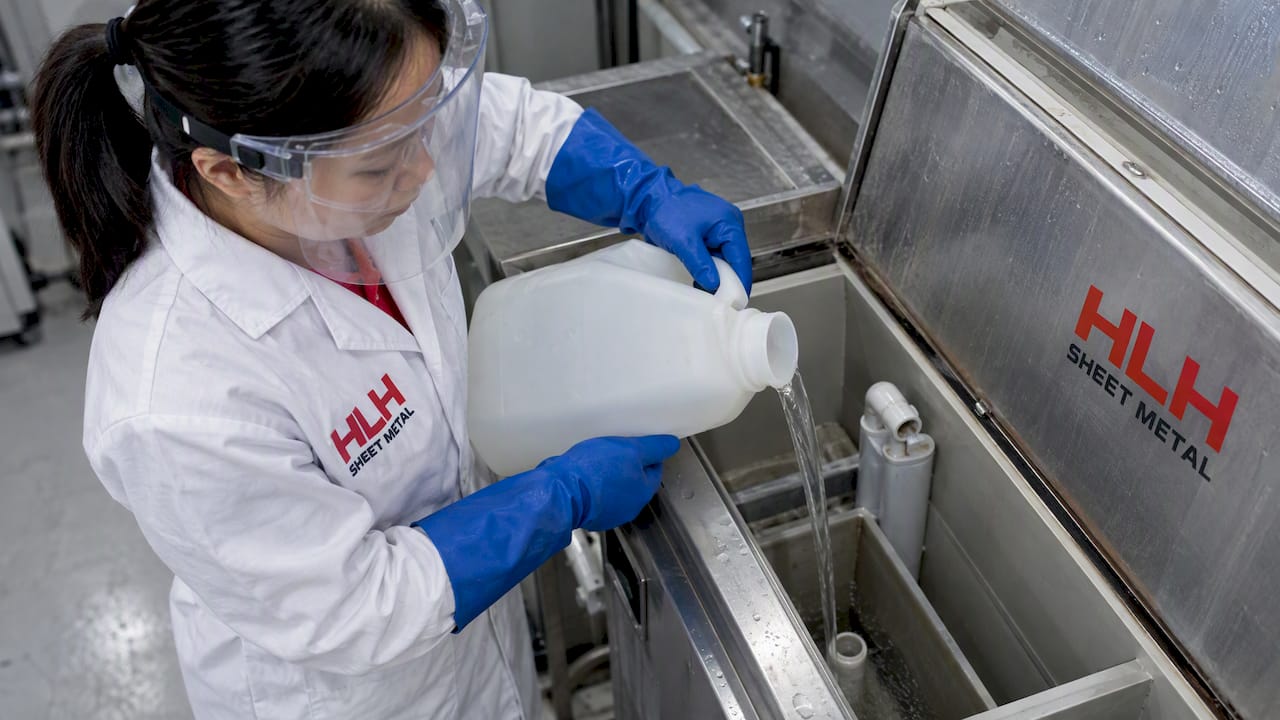 Technician handling salt spray solution safely
